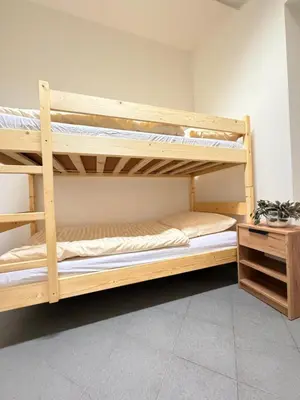 two bunk beds in a room with a desk at Sleep & Go Czech Republic - Praha 5 Anděl in Prague
