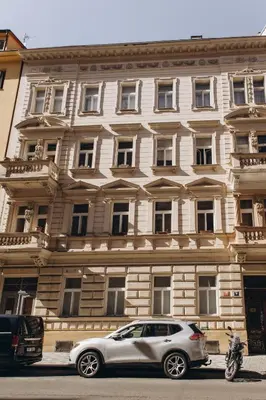 a silver car parked in front of a building at Sleep & Go Czech Republic - Praha 5 Anděl in Prague