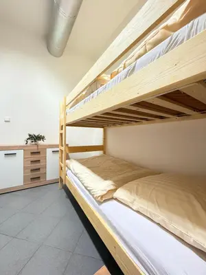 two bunk beds in a room with a counter at Sleep & Go Czech Republic - Praha 5 Anděl in Prague