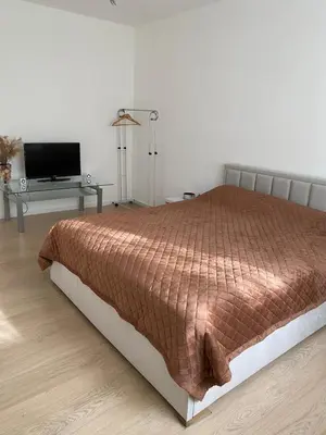 a bedroom with a bed with a television and a table at Near city center flat in Prague