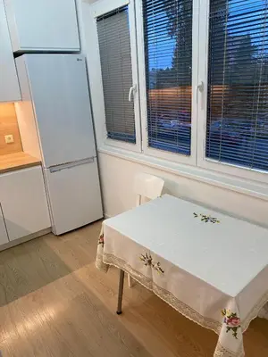 a kitchen with a table and a refrigerator at Near city center flat in Prague