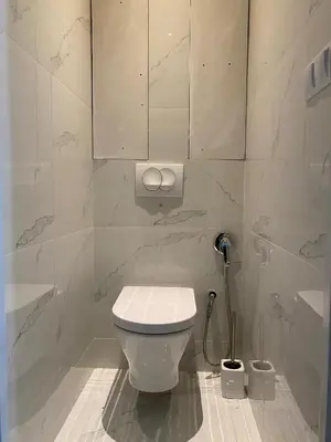 a bathroom with a toilet and a sink and a mirror at Near city center flat in Prague