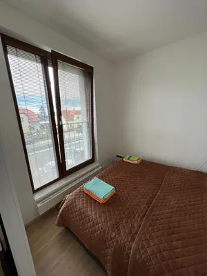 a bedroom with a bed and two windows at Bright & Cosy 1-Bedroom Apartment with Balcony in Prague