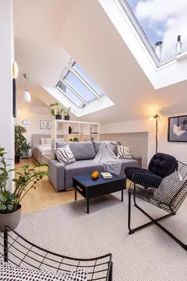 a living room with a couch and a table at TurnKey I Old Town 5BR Loft Apartment in Prague