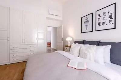 a bedroom with a large bed with a book on it at TurnKey I Old Town 5BR Loft Apartment in Prague