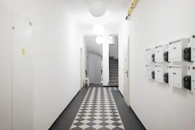 a hallway with a black and white checkered floor at WagnerStays 2BD Suites City Center Residence in Prague