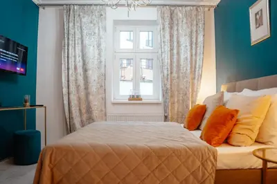 a bedroom with a bed and a window at WagnerStays 2BD Suites City Center Residence in Prague