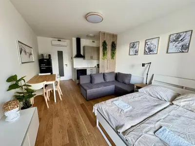 a living room with a couch and a table at Centrum Park District in Prague