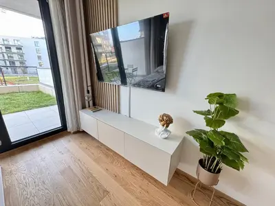 a living room with a flat screen tv on a wall at Centrum Park District in Prague