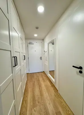 an empty hallway with a door and wooden floors at Centrum Park District in Prague