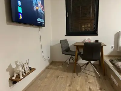 a room with a table and a chair and a television at Romantic apartment by the city center in Prague