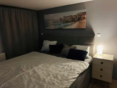 a bedroom with a bed and a painting on the wall at Romantic apartment by the city center in Prague
