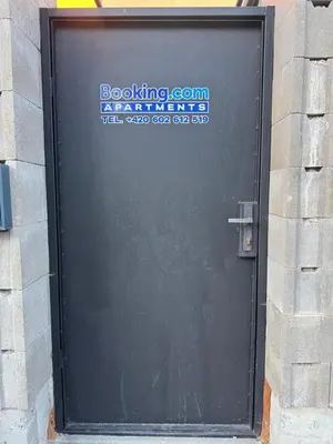 a black garage door with a sign on it at Suterénní apartmán na Hejtmánce u letiště v Mladé Boleslavi in Mladá Boleslav