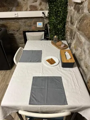 a table with a white table cloth and a plate of food at Suterénní apartmán na Hejtmánce u letiště v Mladé Boleslavi in Mladá Boleslav