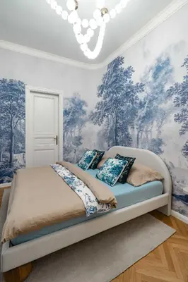 a bedroom with a bed with blue and white wallpaper at Riverside N22 in Prague