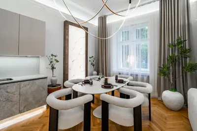 a dining room with a white table and chairs at Riverside N22 in Prague