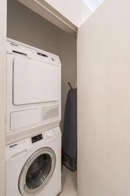 a washing machine and a washer in a room at Riverside N22 in Prague