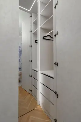 a walk in closet with white walls and shelves at Riverside N22 in Prague