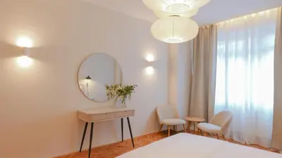 a dressing room with a mirror and a table and chairs at Royal Apartment on Wenceslas Square in Prague