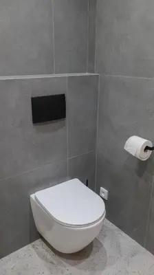a bathroom with a toilet and a roll of toilet paper at Royal Apartment on Wenceslas Square in Prague