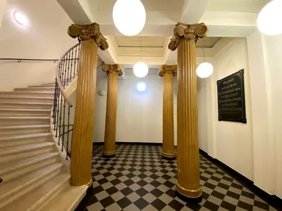 a hallway with columns and stairs in a building at Diamond on Wenceslas Square in Prague