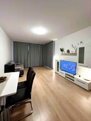 a living room with a television and a table and chairs at Diamond on Wenceslas Square in Prague