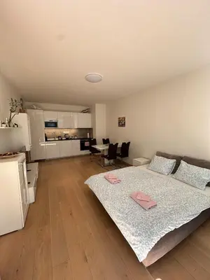a large bedroom with a bed and a kitchen at Diamond on Wenceslas Square in Prague