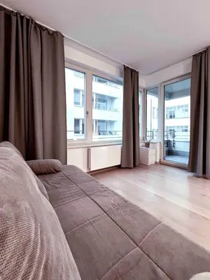 a bedroom with a bed and large windows at Diamond on Wenceslas Square in Prague