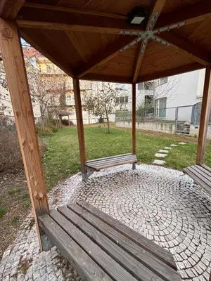 two benches sitting under a pavilion in a park at Diamond on Wenceslas Square in Prague