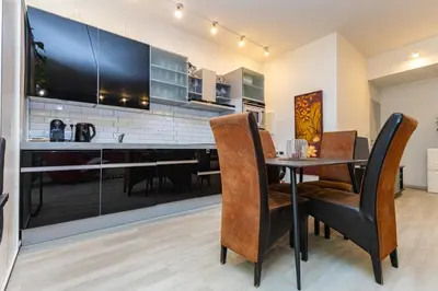 a kitchen with a table and chairs in a room at Apartmán u parku Parukářka in Prague