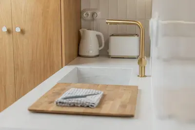 a kitchen counter with a cutting board and a sink at NEW! Mini-designer rooftop AC & Garden, Castle! in Prague