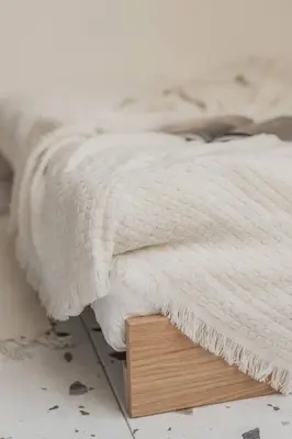 a bed with a white blanket on a wooden platform at NEW! Mini-designer rooftop AC & Garden, Castle! in Prague
