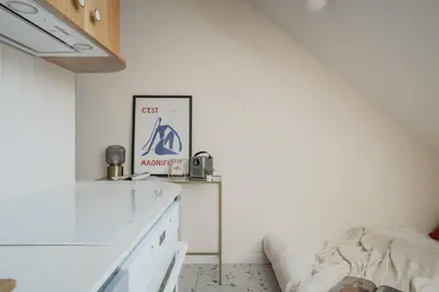 a white room with a bed and a table at NEW! Mini-designer rooftop AC & Garden, Castle! in Prague
