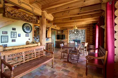 a dining room with a table and chairs at Ranči v Buši - pokoj ve srubu in Čím