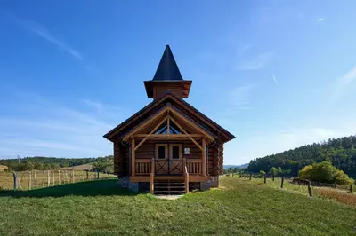 a small cabin in a field with a steeple at Ranči v Buši - pokoj ve srubu in Čím