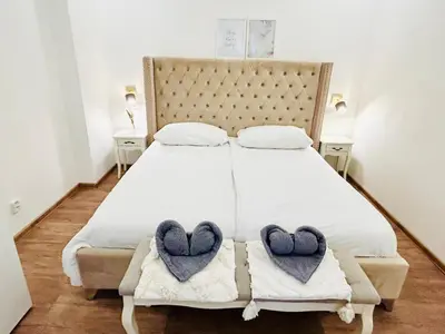 a bedroom with a bed with two hearts on it at New luxury style apartment in central Prague in Prague