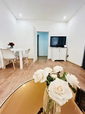 a vase with flowers on a table in a living room at New luxury style apartment in central Prague in Prague