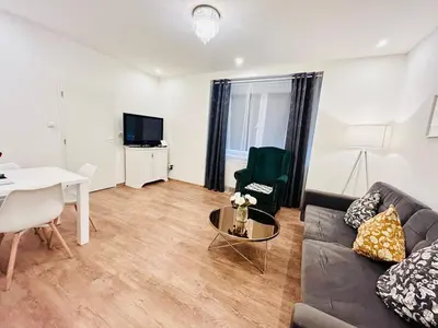 a living room with a couch and a table at New luxury style apartment in central Prague in Prague