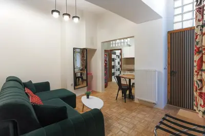 a living room with a green couch and a table at Luxury 1 bedroom apartment in Central Prague in Prague