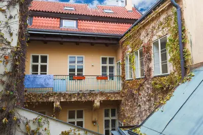 an apartment building with a balcony and ivy at Luxury 1 bedroom apartment in Central Prague in Prague