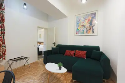 a living room with a green couch and a table at Luxury 1 bedroom apartment in Central Prague in Prague