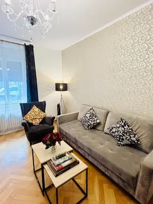 a living room with a couch and a table at Luxury and cozy apartment Vinohrady Prague in Prague