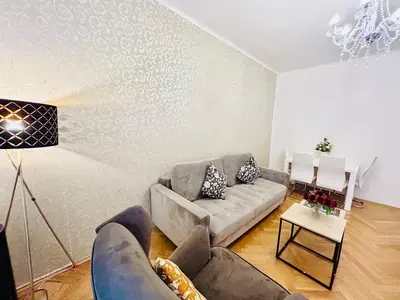 a living room with a couch and a table at Luxury and cozy apartment Vinohrady Prague in Prague