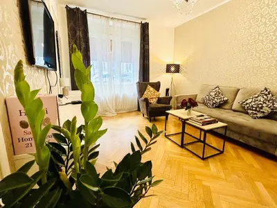 a living room with a couch and a table at Luxury and cozy apartment Vinohrady Prague in Prague