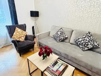 a living room with a couch and a chair at Luxury and cozy apartment Vinohrady Prague in Prague