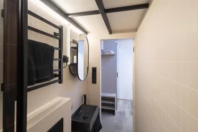 a bathroom with a sink and a mirror at Rentero Designer Petite Stay, Prague in Prague