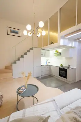 a living room with a couch and a table at Rentero Designer Petite Stay, Prague in Prague