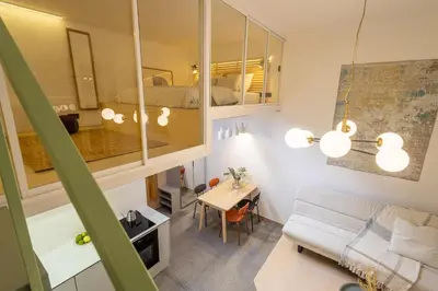 a small apartment with a bed and a living room at Rentero Designer Petite Stay, Prague in Prague