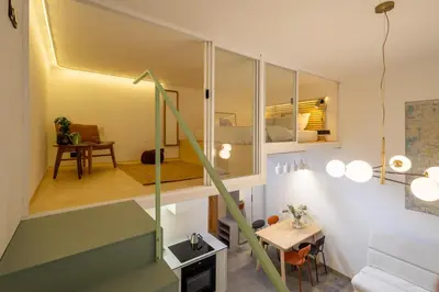 a small apartment with a staircase leading to a room at Rentero Designer Petite Stay, Prague in Prague