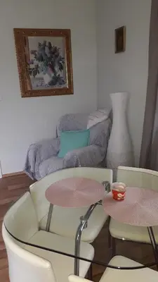 a living room with a table and two chairs and a couch at Dreamy Apartment in Prague